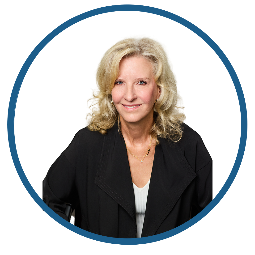 Professional woman with blonde hair in black blazer smiling.