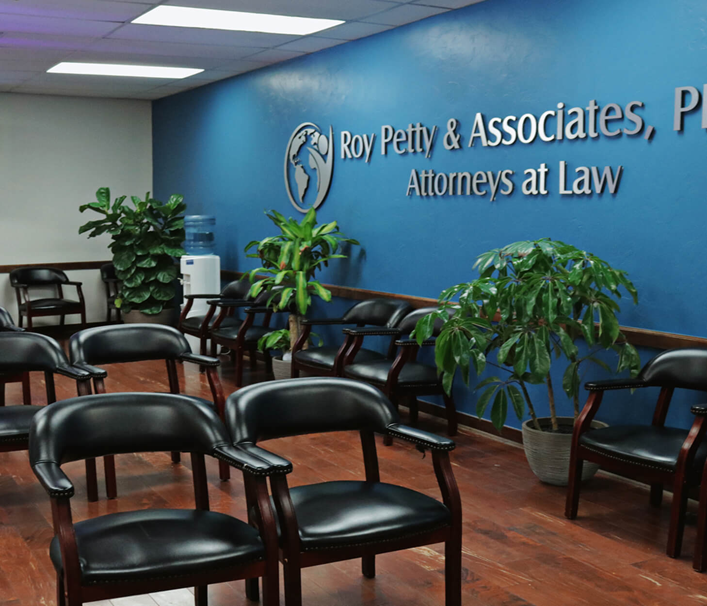 Waiting area inside a law office with chairs and plants.